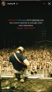 Caamp Instagram story showing a back-facing guitarist kneeling onstage with a rainbow strap in front of a large, cheering festival crowd, and text above teasing "toronto + chicago, we’re playing you too... happy vday lovers.